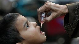 A health worker administers a polio vaccine to a child in Karachi, Pakistan, on January 8, 2024.