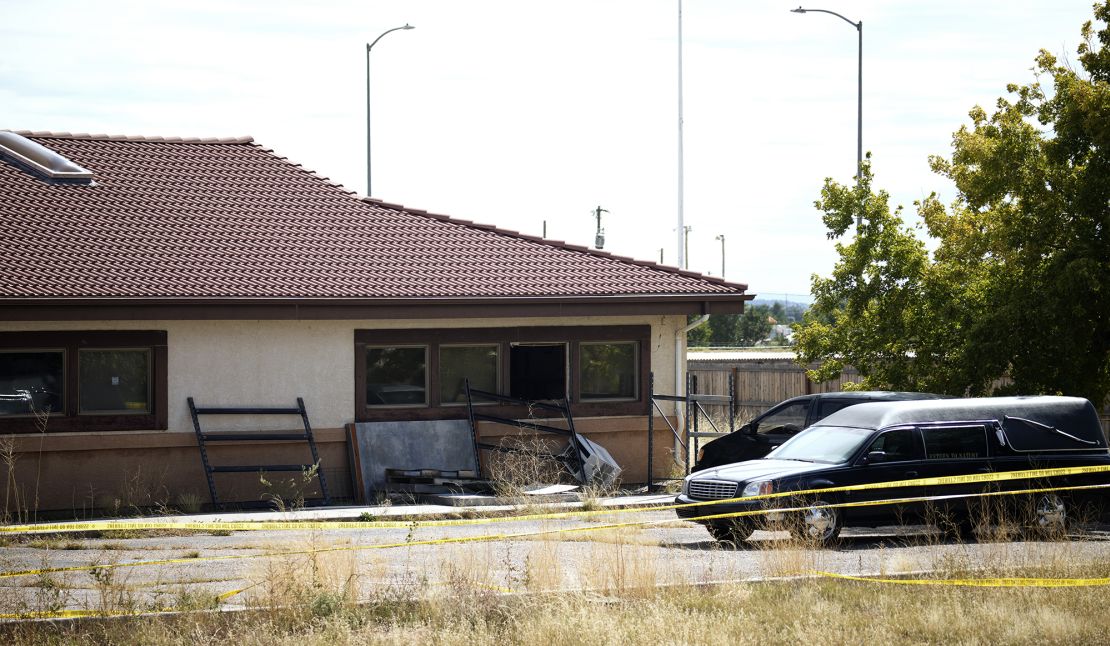 A hearse and van sit outside the Return to Nature Funeral Home in Penrose, Colorado on October 6, 2023.