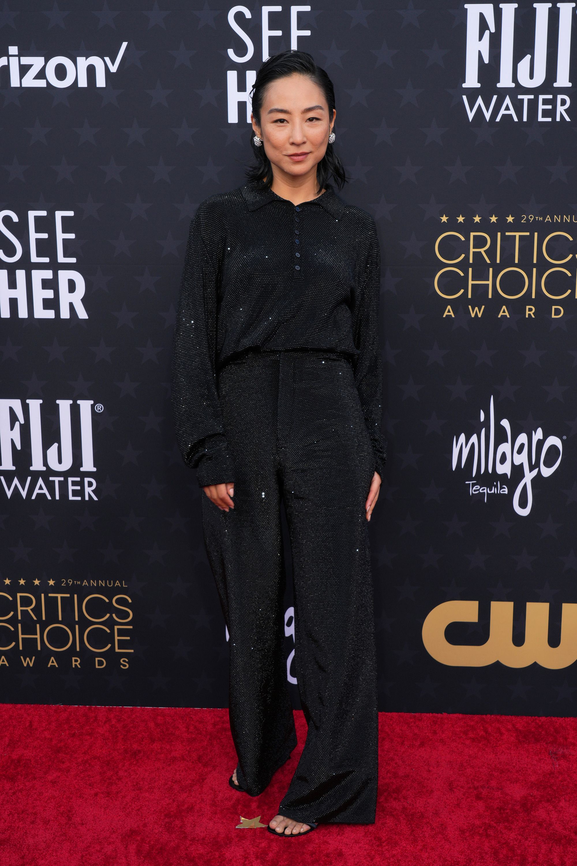 Greta Lee, nominated in the best actress category for "Past Lives," wore a sparkly all-black look from Loewe’s Spring-Summer 2024 ready-to-wear menswear collection.
