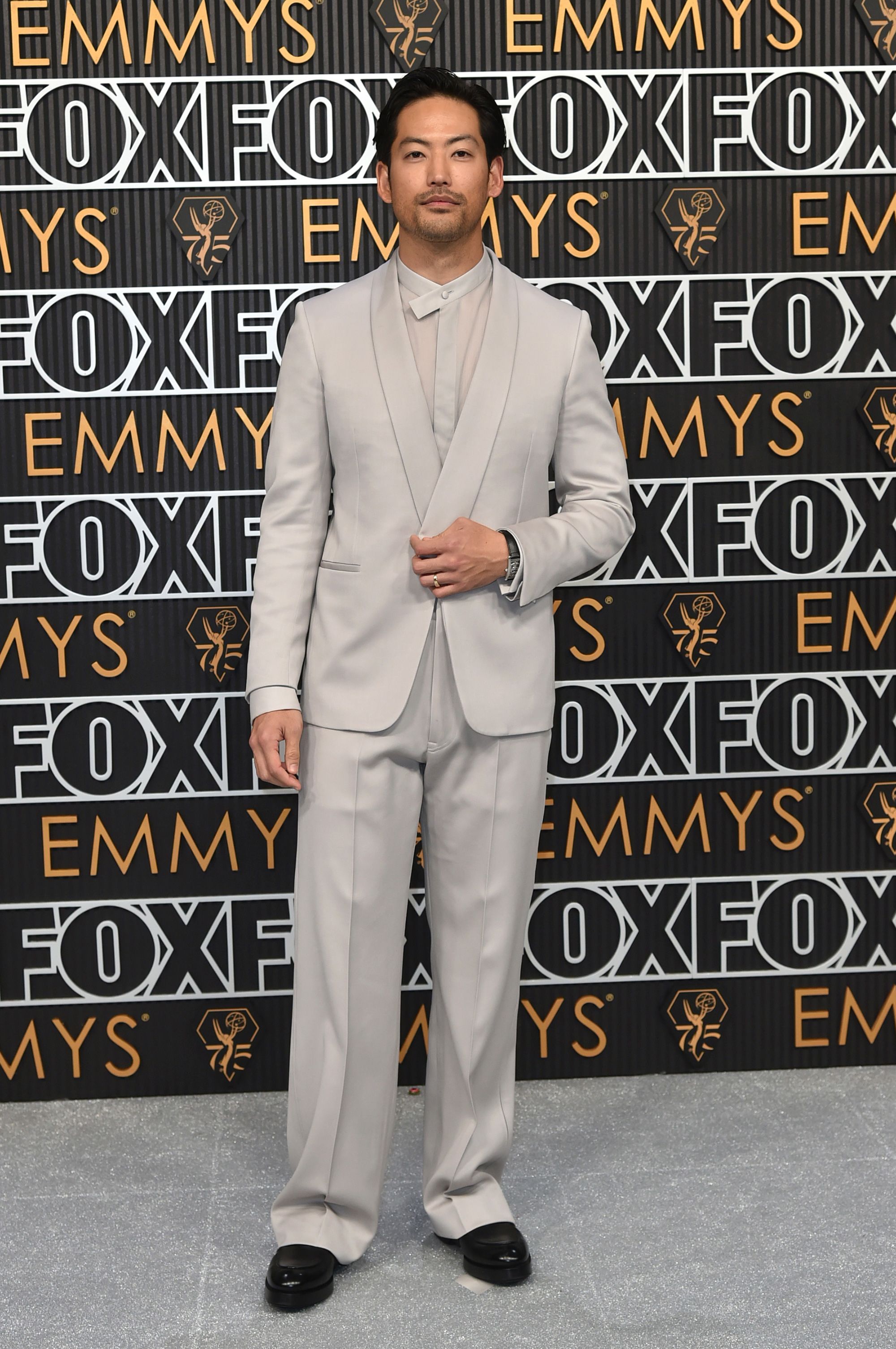 “Beef” actor Joseph Lee wore an all beige-grey suit with a playful mandarin collared shirt.