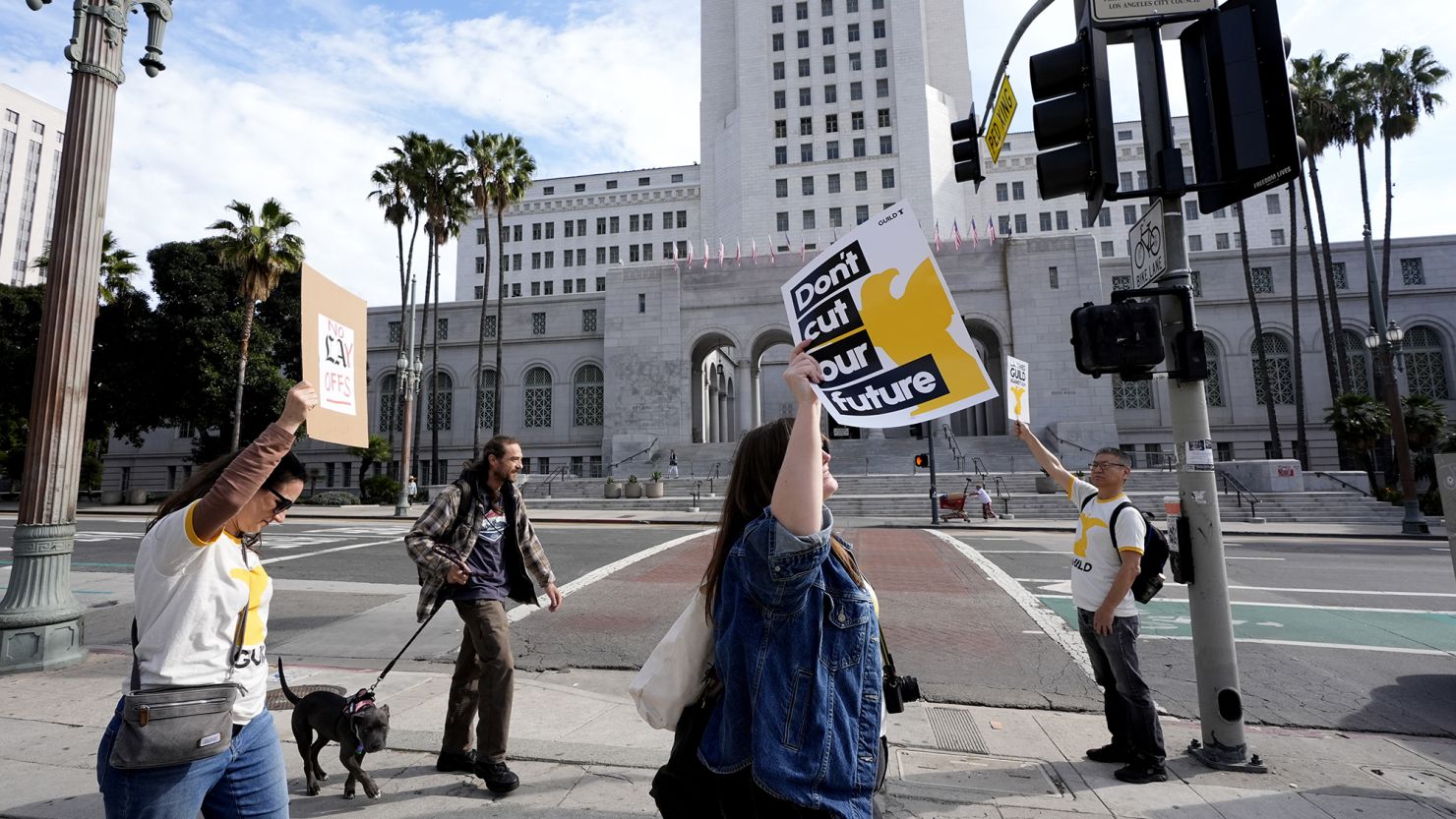 Staff and supporters of the Los Angeles Times carry signs across the street from Los Angeles City Hall during a rally on Friday, Jan. 19, 2024.