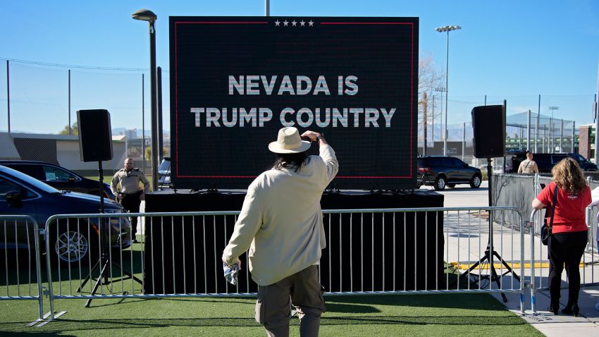 A person takes a picture of a screen before Republican presidential candidate former President Donald Trump speaks at a campaign event on January 27, 2024, in Las Vegas.