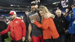 Kansas City Chiefs tight end Travis Kelce and Taylor Swift walk together after an AFC Championship NFL football game January 28.