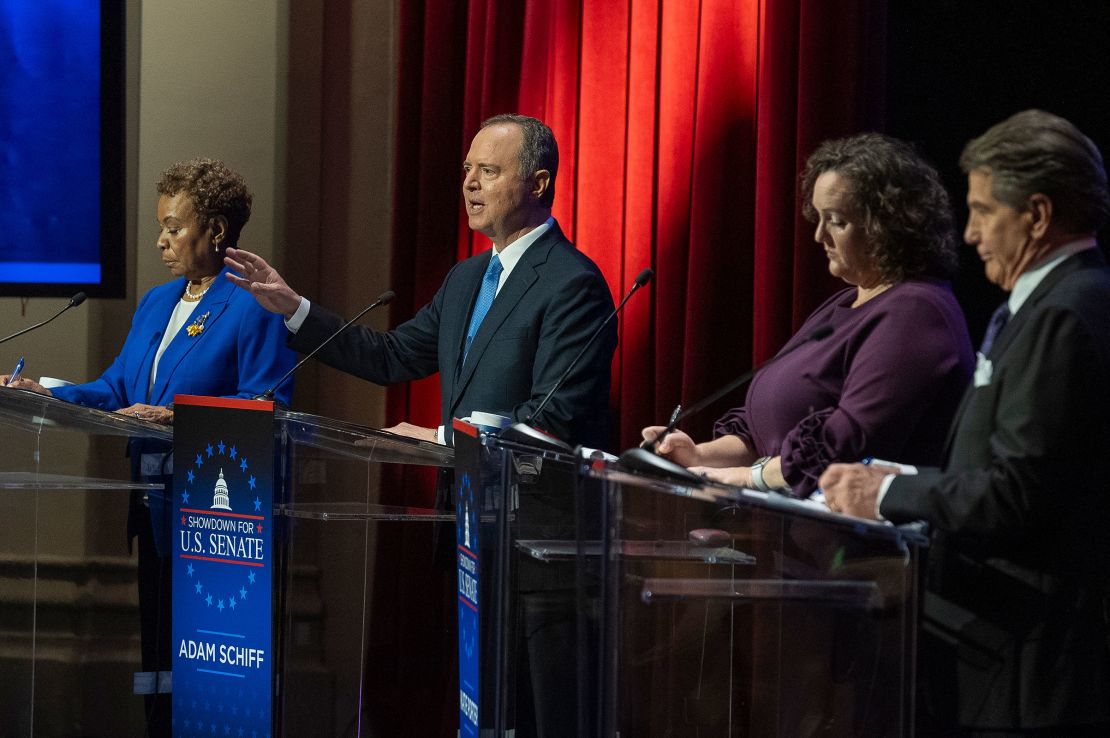 Rep. Adam Schiff, second from left, speaks as Reps. Barbara Lee and Katie Porter and former baseball player Steve Garvey listen on stage during a televised debate on January 22 in Los Angeles.