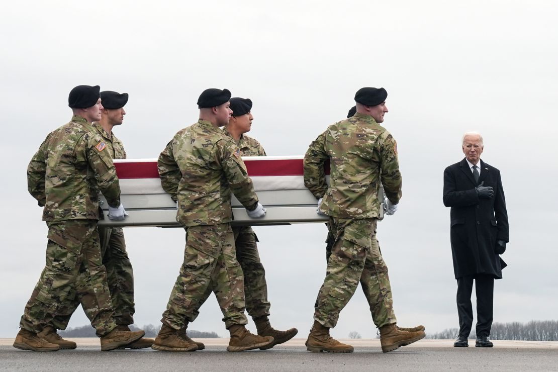 US President Joe Biden, right, stands as an Army carry team moves the transfer case containing the remains of US Army Sgt. Kennedy Ladon Sanders, 24, at Dover Air Force Base, Delaware on February 2. Sanders was killed in a drone attack in Jordan on January 28.