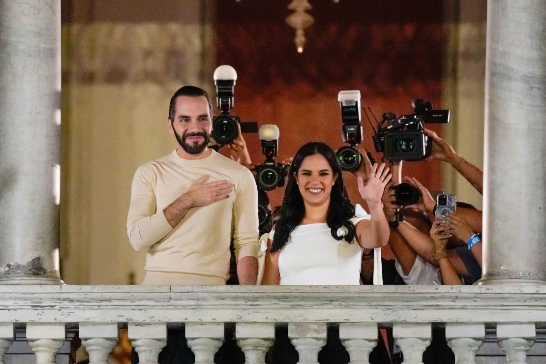 El Salvador President Nayib Bukele, left, accompanied by his wife Gabriela Rodriguez, waves to supporters from the balcony of the presidential palace in San Salvador, El Salvador, after polls closed on Sunday.