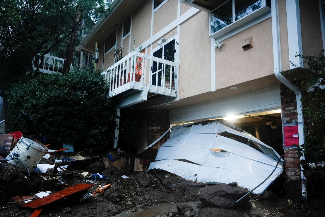 A garage door is damaged by a storm on a home on Monday in Studio City.