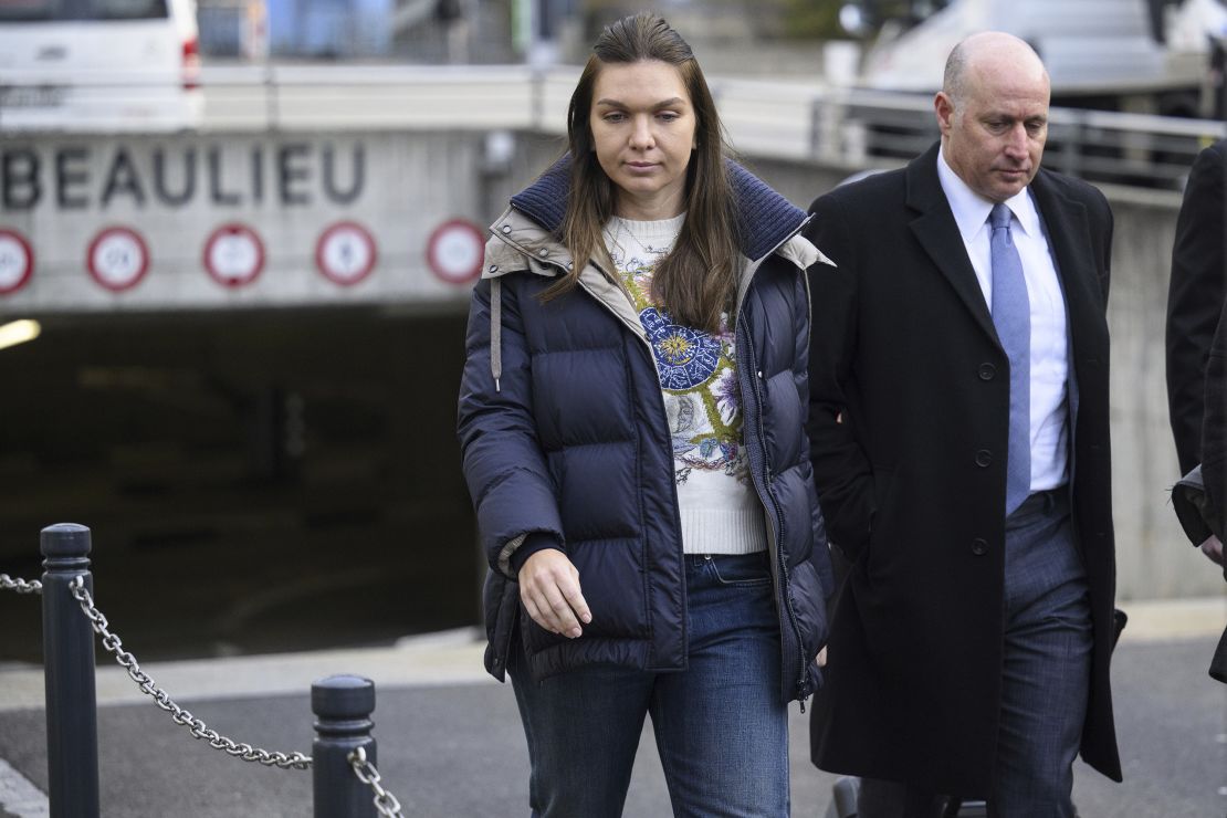 Halep arrives with her lawyer for a hearing.