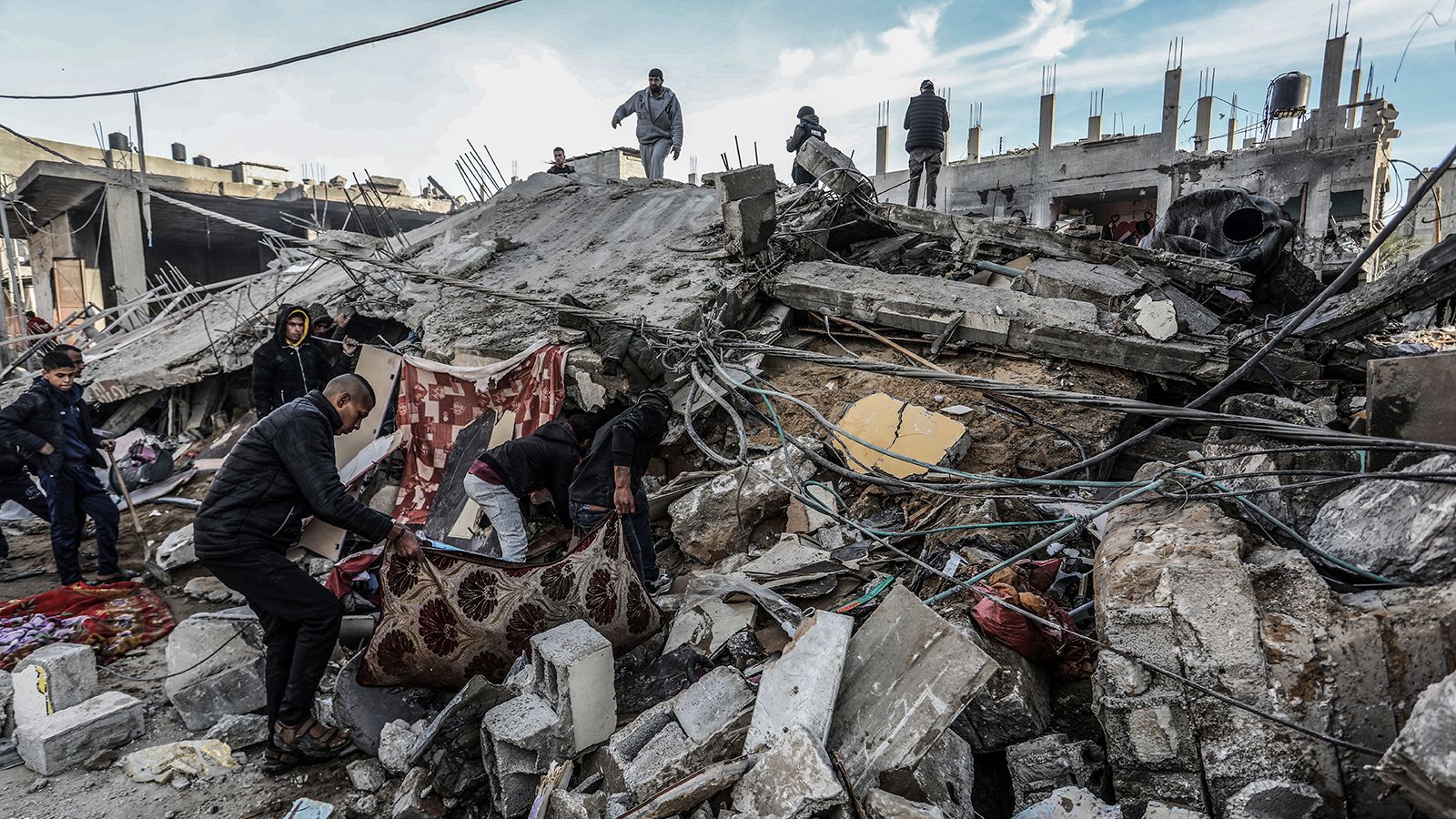 Palestinians inspect damaged buildings after Israeli airstrikes on Rafah, southern Gaza, on February 12, 2024.