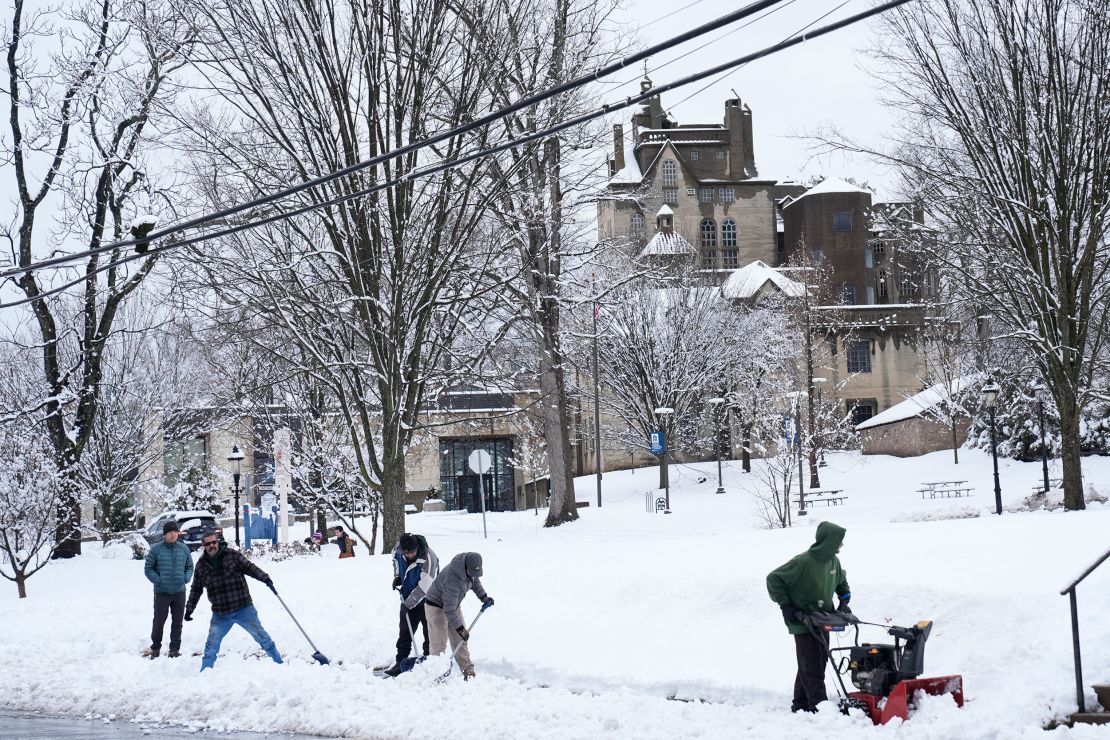 A crew clears snow from a sidewalk in Doylestown, Pennsylvania.