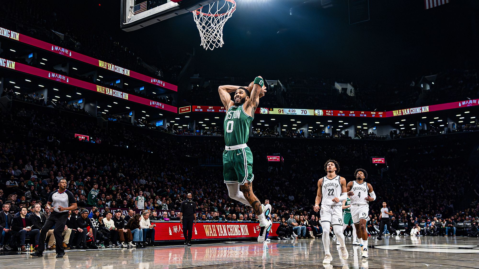 Tatum throws down a dunk during the game.