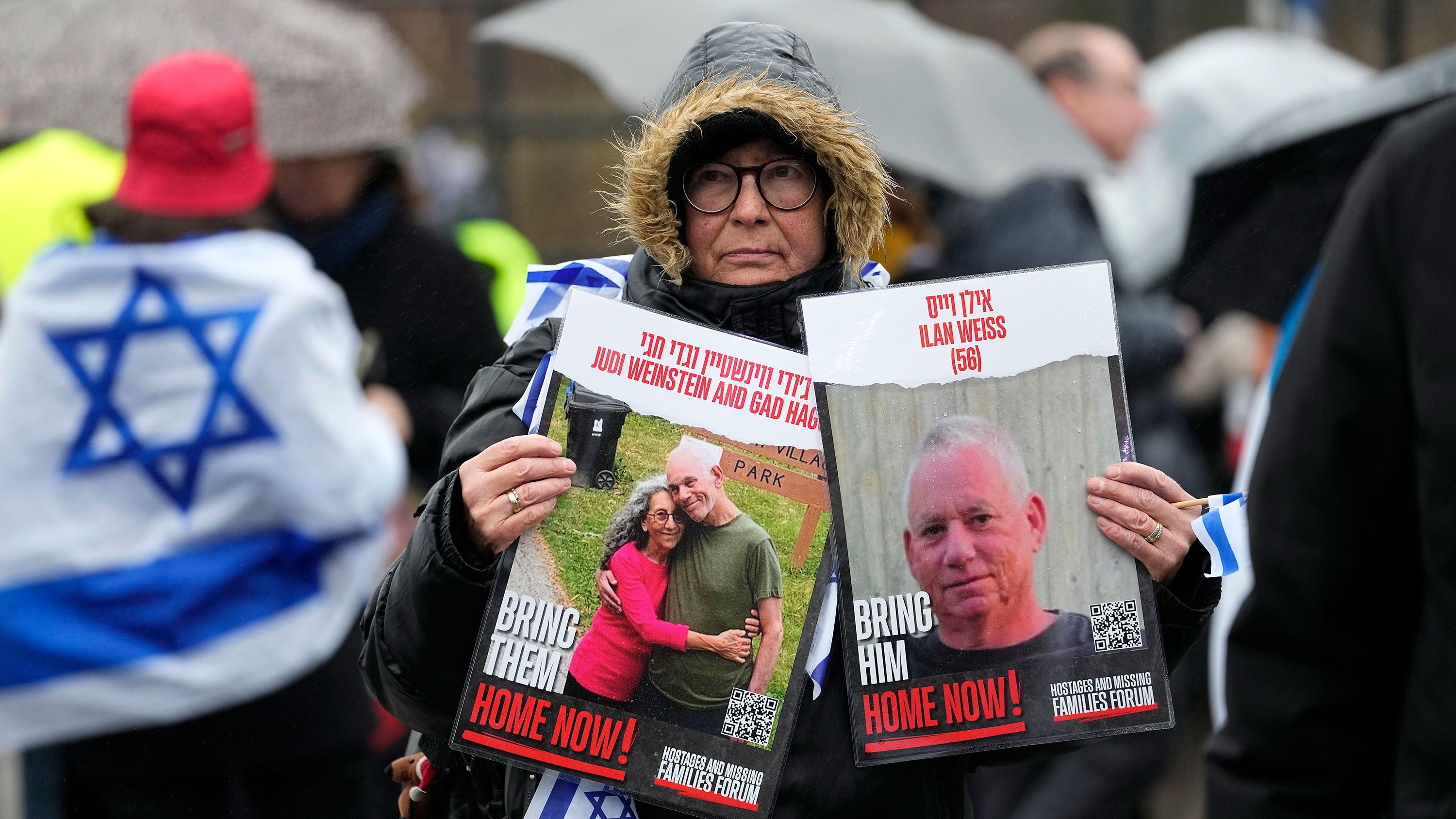 A woman holds images of hostages at The Hague on Wednesday, February 14 during a demonstration.