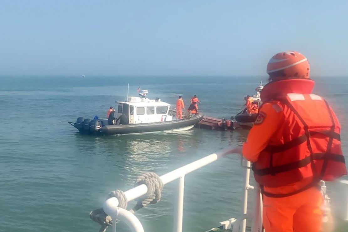 Taiwan's coast guard inspects a vessel that capsized during a chase off the coast of the Kinmen islands on February 14, 2024.