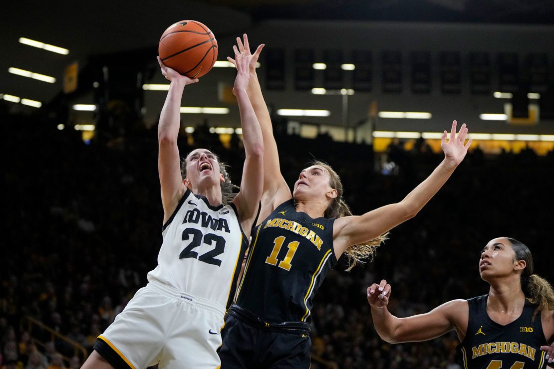 Clark, left, pulls up for a shot as Michigan guard Greta Kampschroeder (No. 11) defends during the second half of Thursday's game.