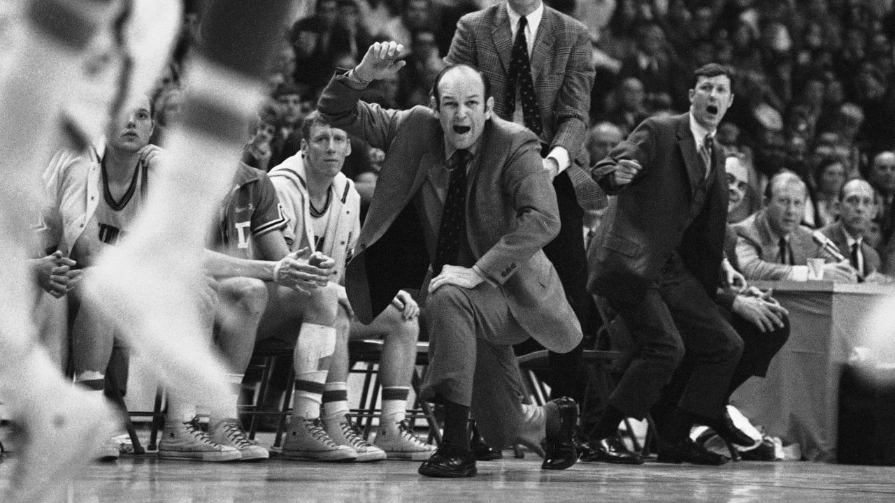 FILE - Davidson head coach Lefty Driesell drops to a knee in front of his bench as he watches North Carolina win on March 15, 1969 NCAA Eastern Regional basketball tournament at College Park, Md. Lefty Driesell, the coach whose folksy drawl belied a fiery on-court demeanor that put Maryland on the college basketball map and enabled him to rebuild several struggling programs, died Saturday, Feb. 17, 2024. He was 92. (AP Photo/File)