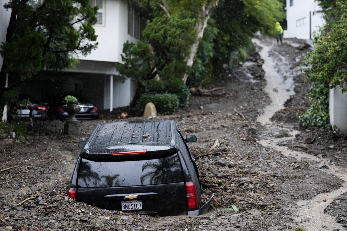 An SUV sits buried by a mudslide on Feb. 5, 2024, in the Beverly Crest area of Los Angeles. El Niño has a strong linkage to a wetter winter in California like what happened this year.