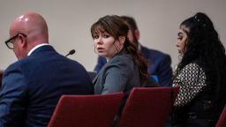 Hannah Gutierrez-Reed, center, sits with her attorney Jason Bowles, left, during the first day of testimony in the trial against her in Santa Fe, New Mexico, on February 22, 2024.