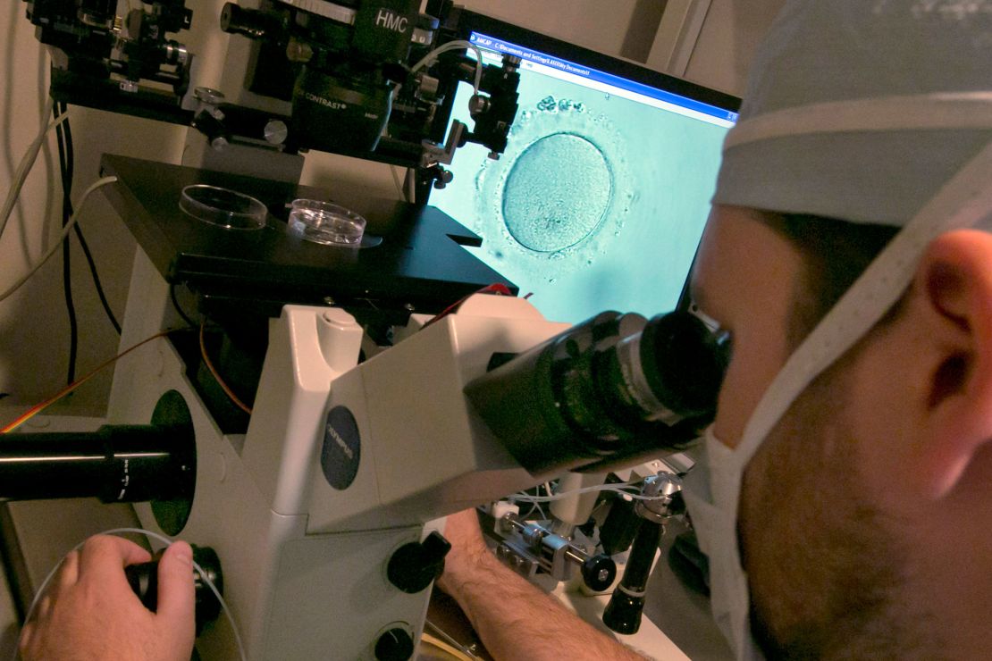 An embryologist uses a microscope to view an embryo in this photo from 2013.