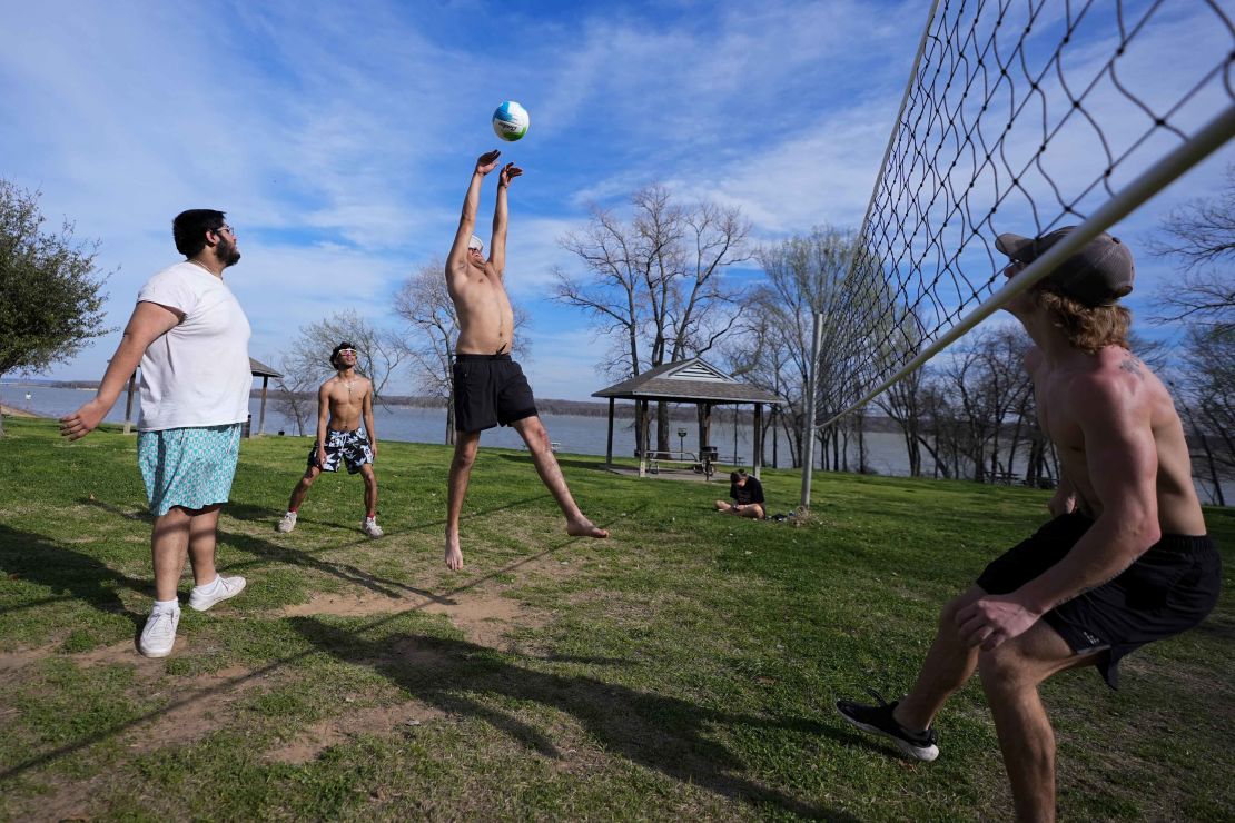 Friends play volleyball during a day that felt more like June than February in Grand Prairie, Texas, on Monday, February 26.