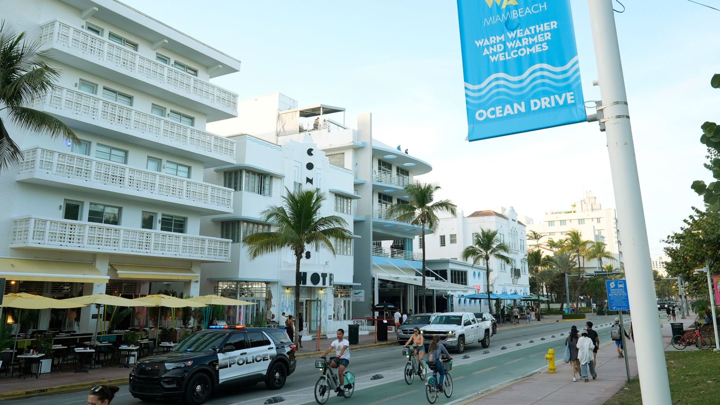 A police car cruises Ocean Drive February 27 in Miami Beach, Florida. State troopers are being deployed in the city during spring break.