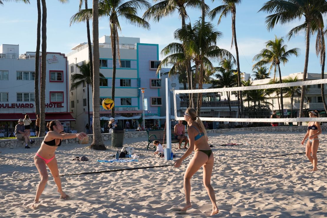 Beachgoers play volleyball along Ocean Drive in Miami Beach on February 27.