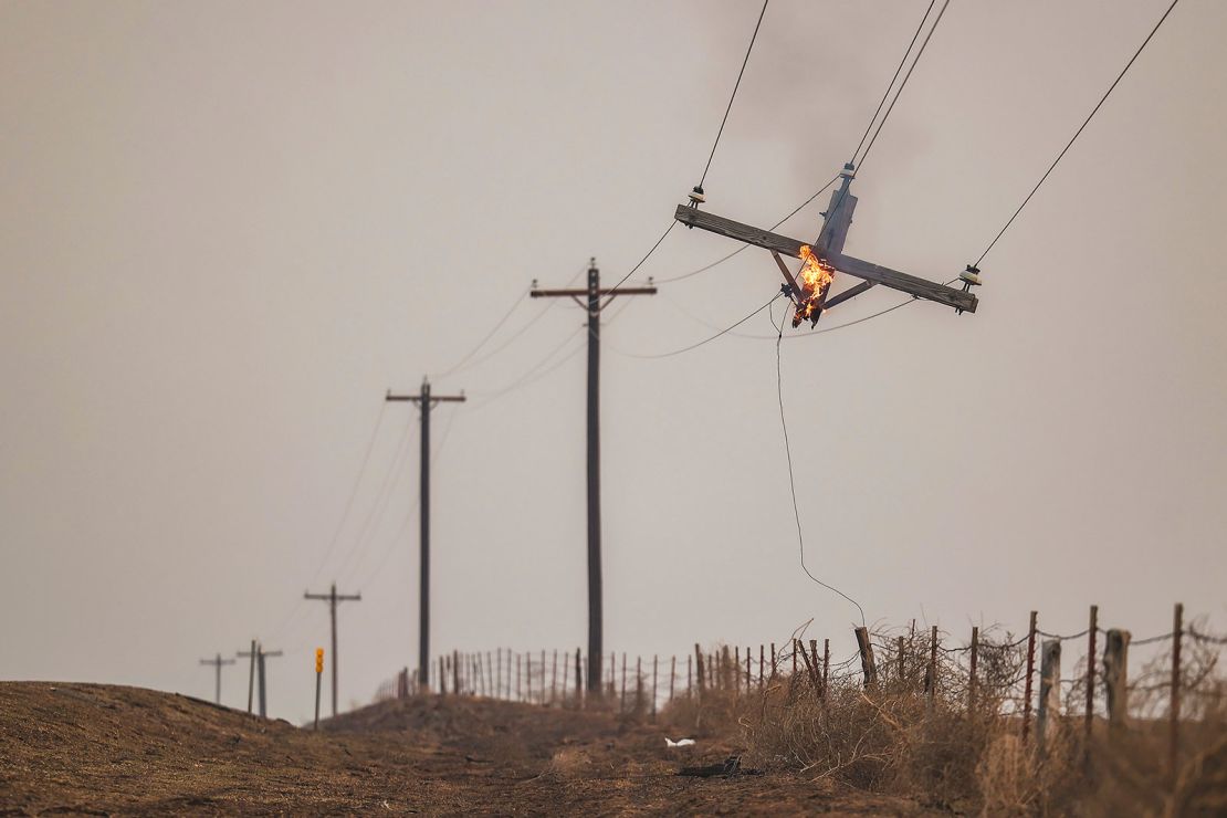 A telephone pole burns from the Smokehouse Creek Fire on Wednesday in Canadian, Texas.