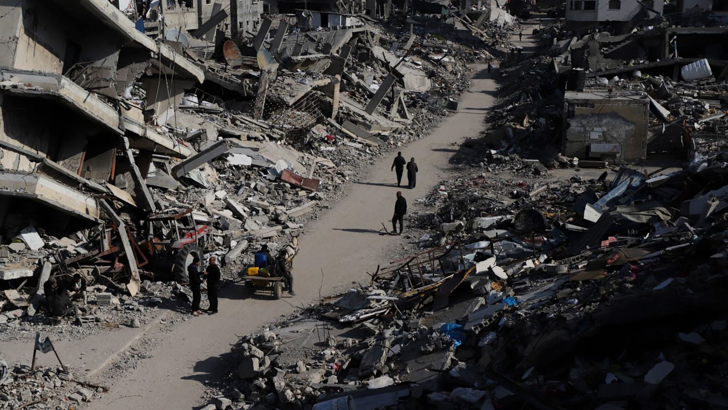 Palestinians walk through the destruction from the Israeli offensive in the Jabaliya refugee camp in the Gaza Strip on Thursday, February 29, 2024.