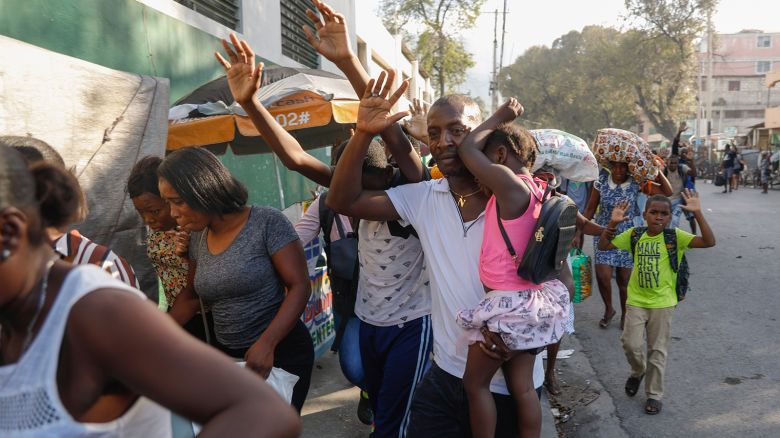 Residents flee their homes during clashes between police and gang member at the Portail neighborhood in Port-au-Prince, Haiti on February 29, 2024.