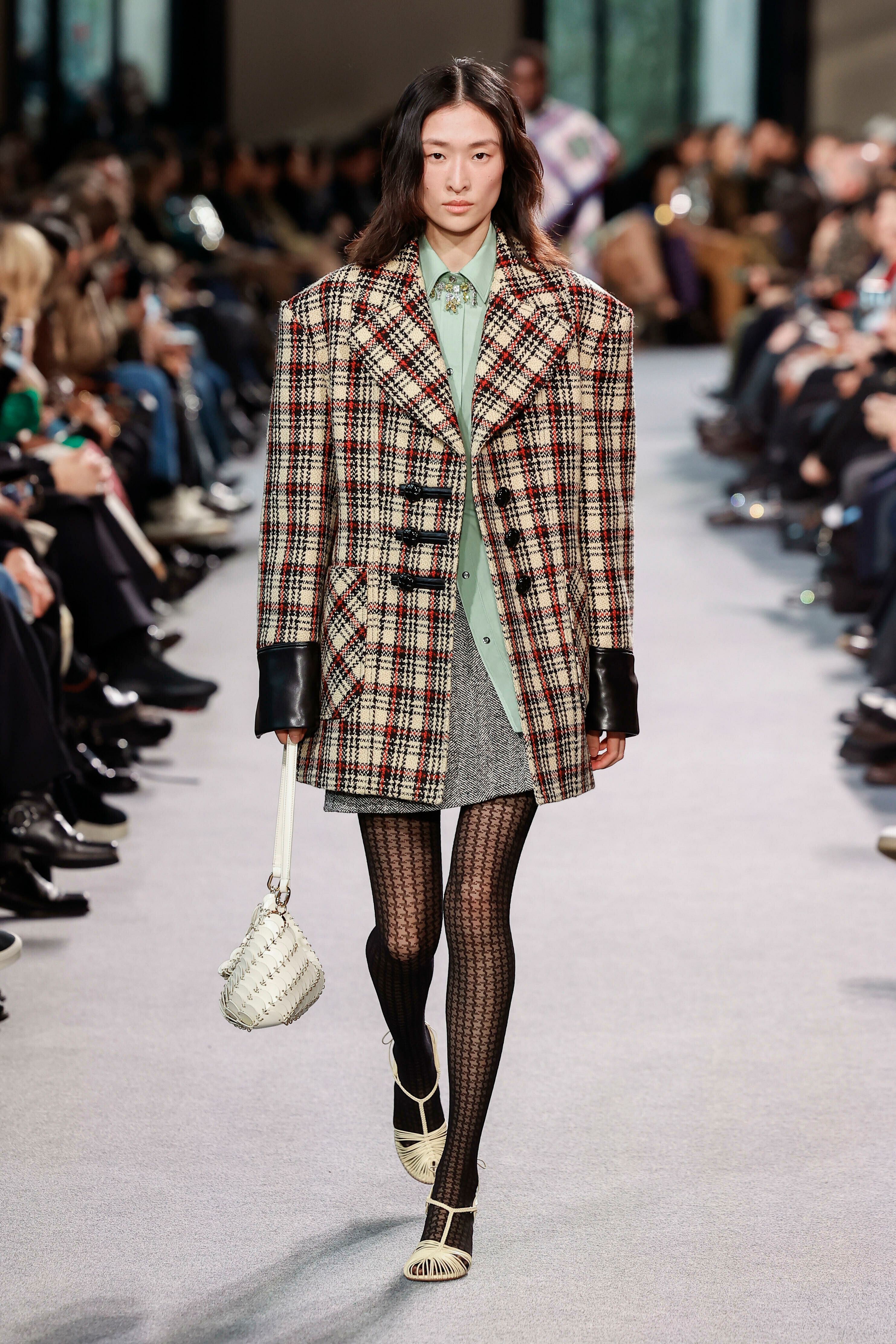 Equally at Rabanne, tartan blazers were given a grungier edge with leather-trimmed sleeves and fasteners.