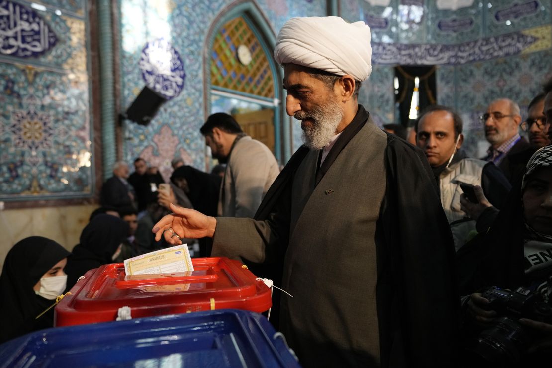A cleric casts his ballot at a polling station in Tehran, Iran, on Friday.