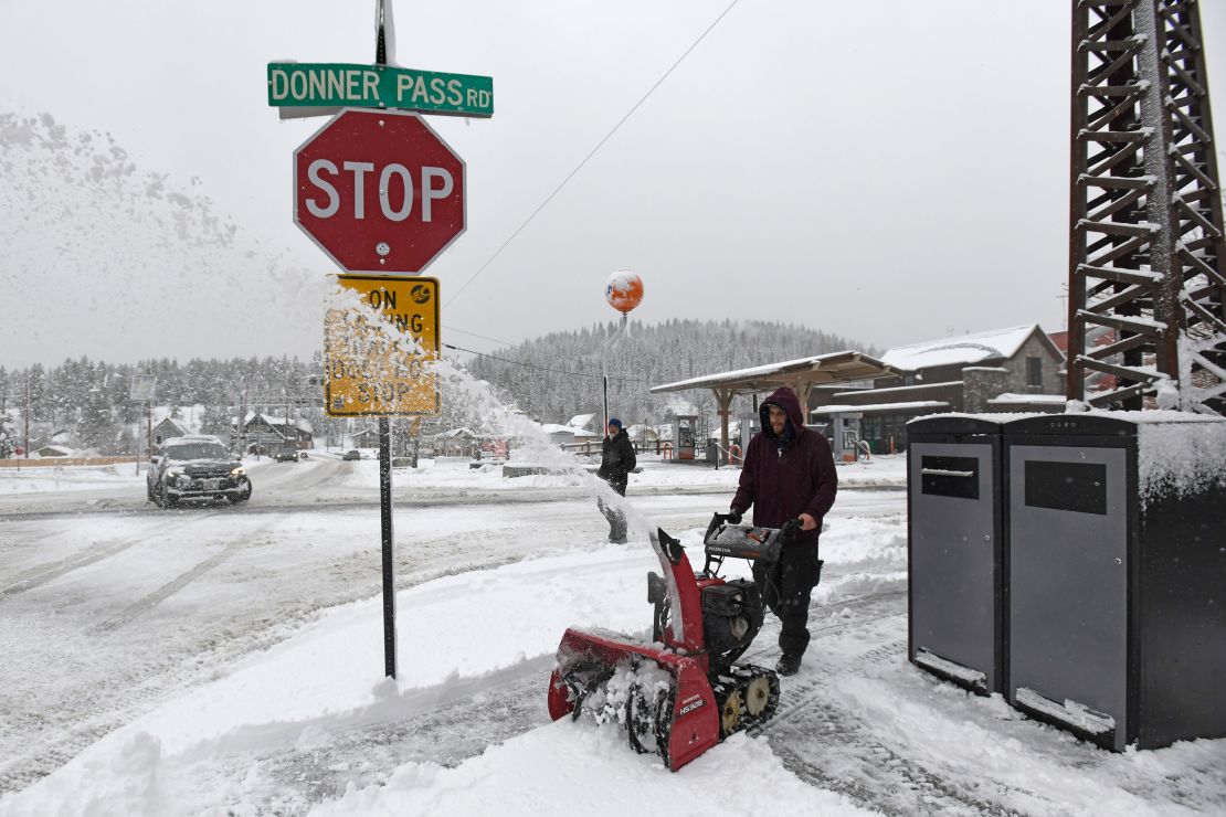 Juan Manuel plows the snow off the sidewalk in downtown Truckee, California, on Friday, March 1, 2024.