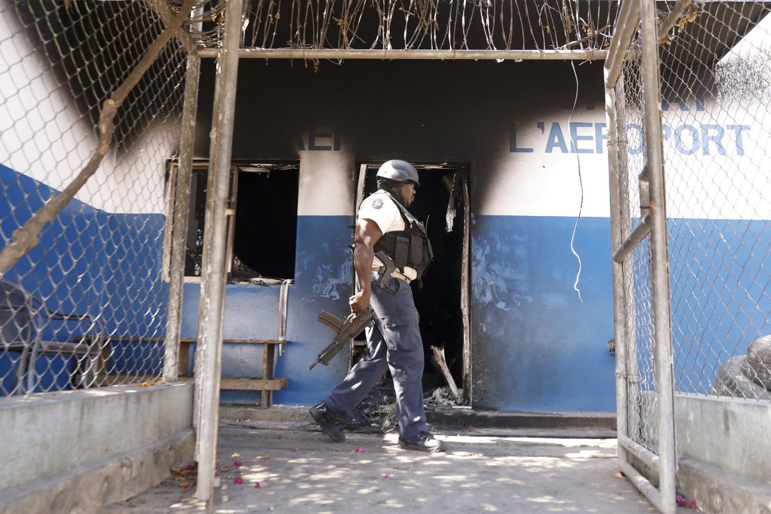 A law enforcement officer at a police station set on fire by armed gangs in Port-au-Prince, Haiti, on March 5, 2024.