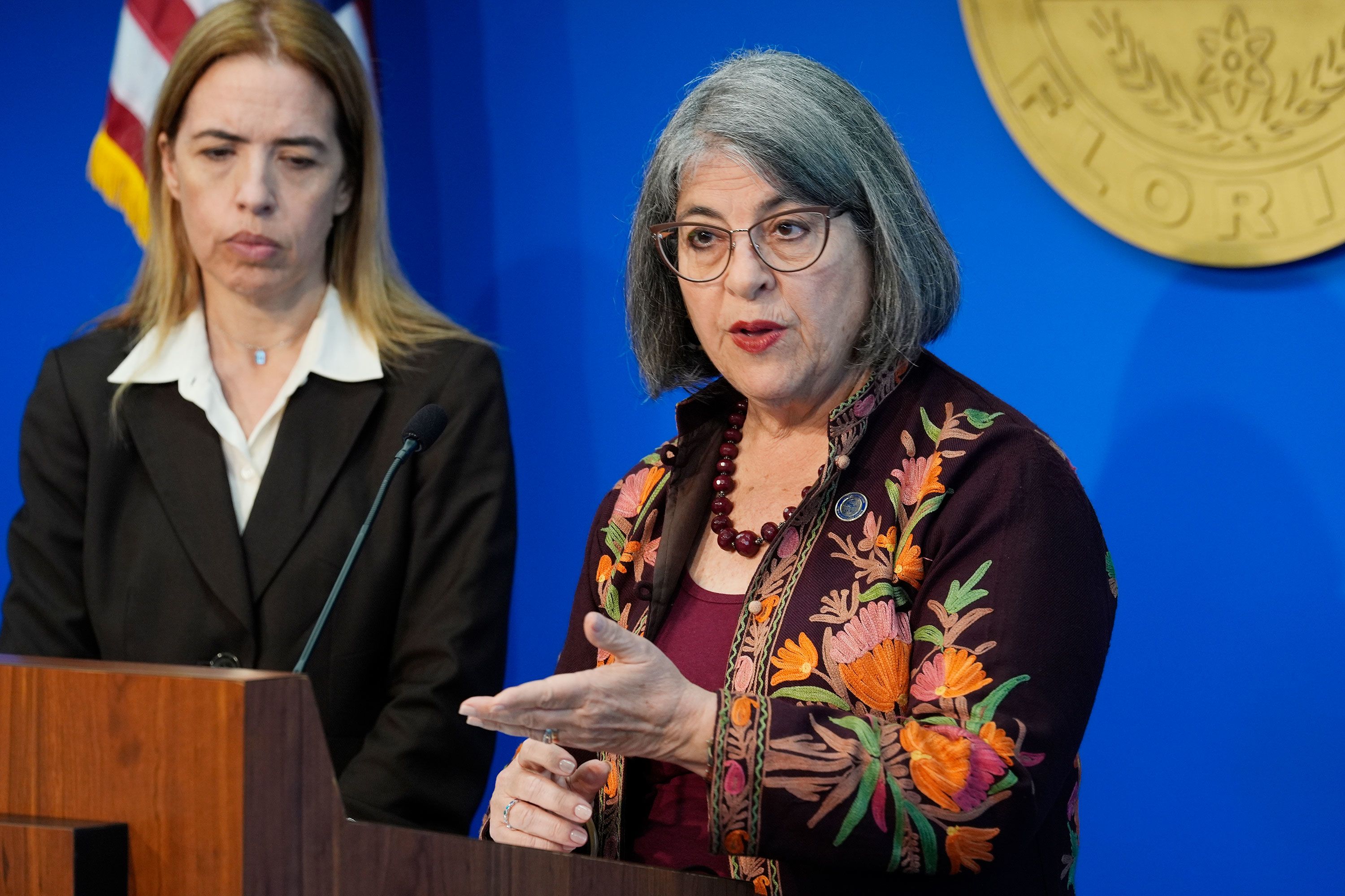 Miami-Dade County Mayor Daniella Levina Cava, right, speaks at a news conference on March 7. She cited a 