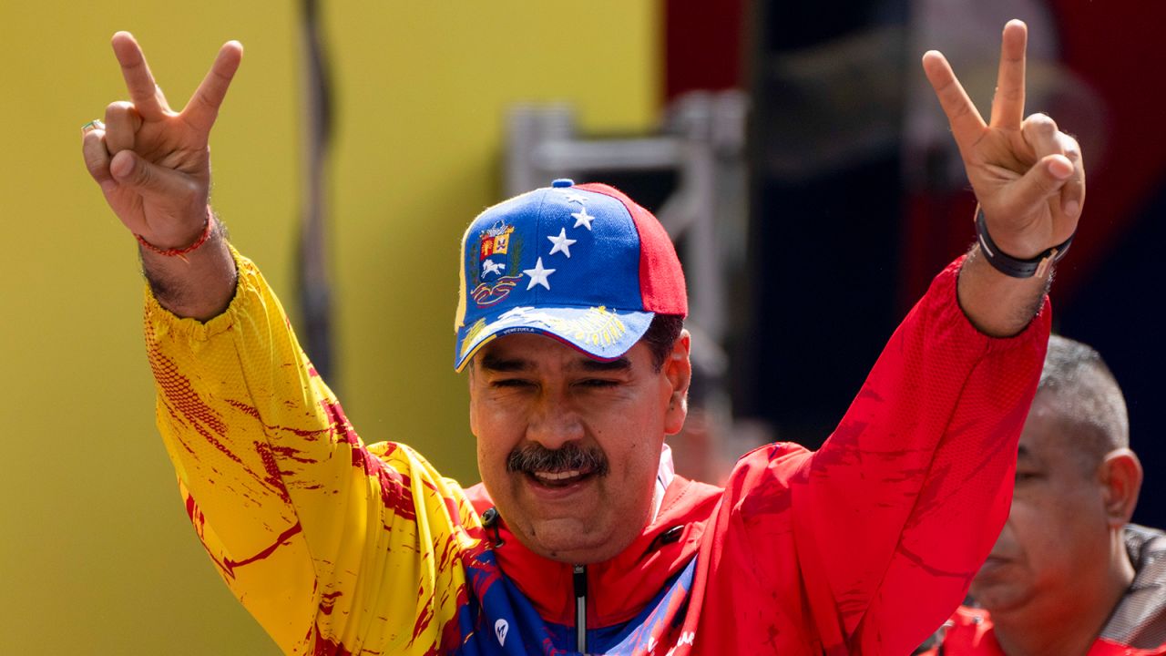 President Nicolas Maduro flashes victory signs during an event in Caracas, Venezuela, on February 29, 2024.