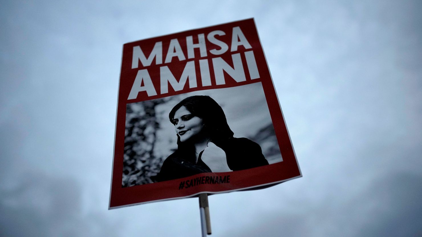 A placard shows a picture of Iranian woman Mahsa Amini during a protest against her death, in Berlin, Germany, on Sept. 28, 2022.