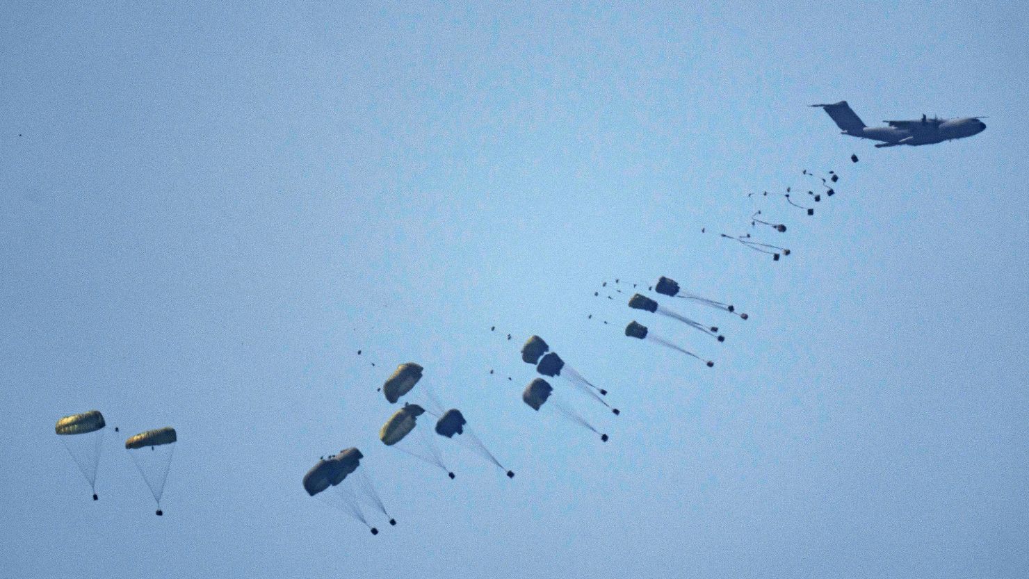 An aircraft airdrops humanitarian aid over Gaza the northern Gaza Strip.