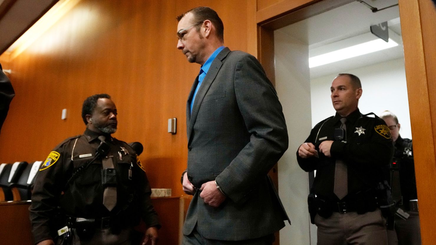 James Crumbley enters an Oakland County, Michigan, courtroom Friday. Shortly after the shooting, he told investigators the murder weapon his son used had been hidden in a case and the bullets were stored separately, according to testimony.