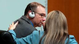 Defense attorney Mariell Lehman puts her arm on James Crumbley after he gets emotional after watching the video of his son walking through the halls of Oxford H.S. in a video shown in the Oakland County courtroom Friday, March 8, 2024, in Pontiac, Mich. Crumbley is on trial for involuntary manslaughter. He's accused of contributing to the tragedy at Oxford High School by failing to properly secure a gun used by son Ethan Crumbley. Four students were killed and more were wounded. (AP Photo/Carlos Osorio, Pool)