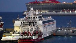 Aid packages are seen at left, on a platform near to the docked ship belonging to the Open Arms aid group, center front, as it prepares to ferry some 200 tonnes of rice and flour directly to Gaza, at the port in Larnaca, Cyprus, Monday, March 11, 2024.