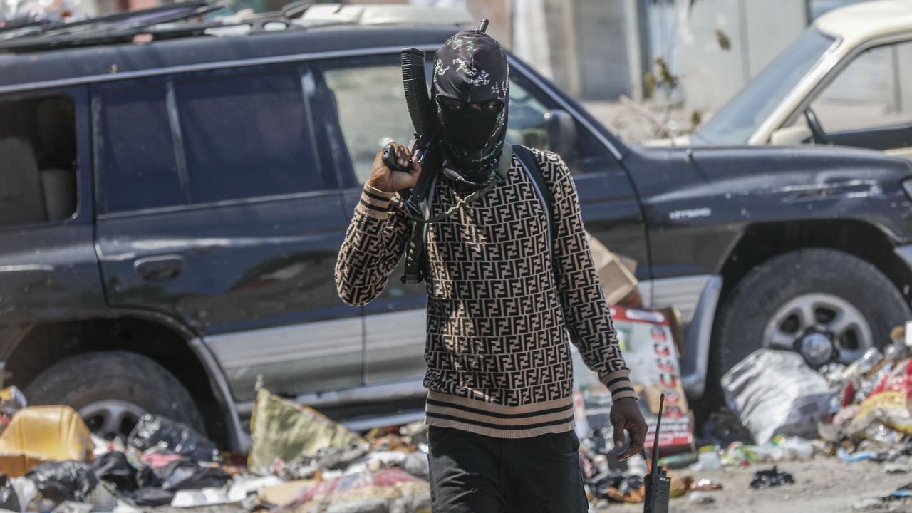 An armed member of the G9 and Family gang patrols a roadblock in the Delmas 6 neighborhood of Port-au-Prince, Haiti, Monday, March 11, 2024. (AP Photo/Odelyn Joseph)