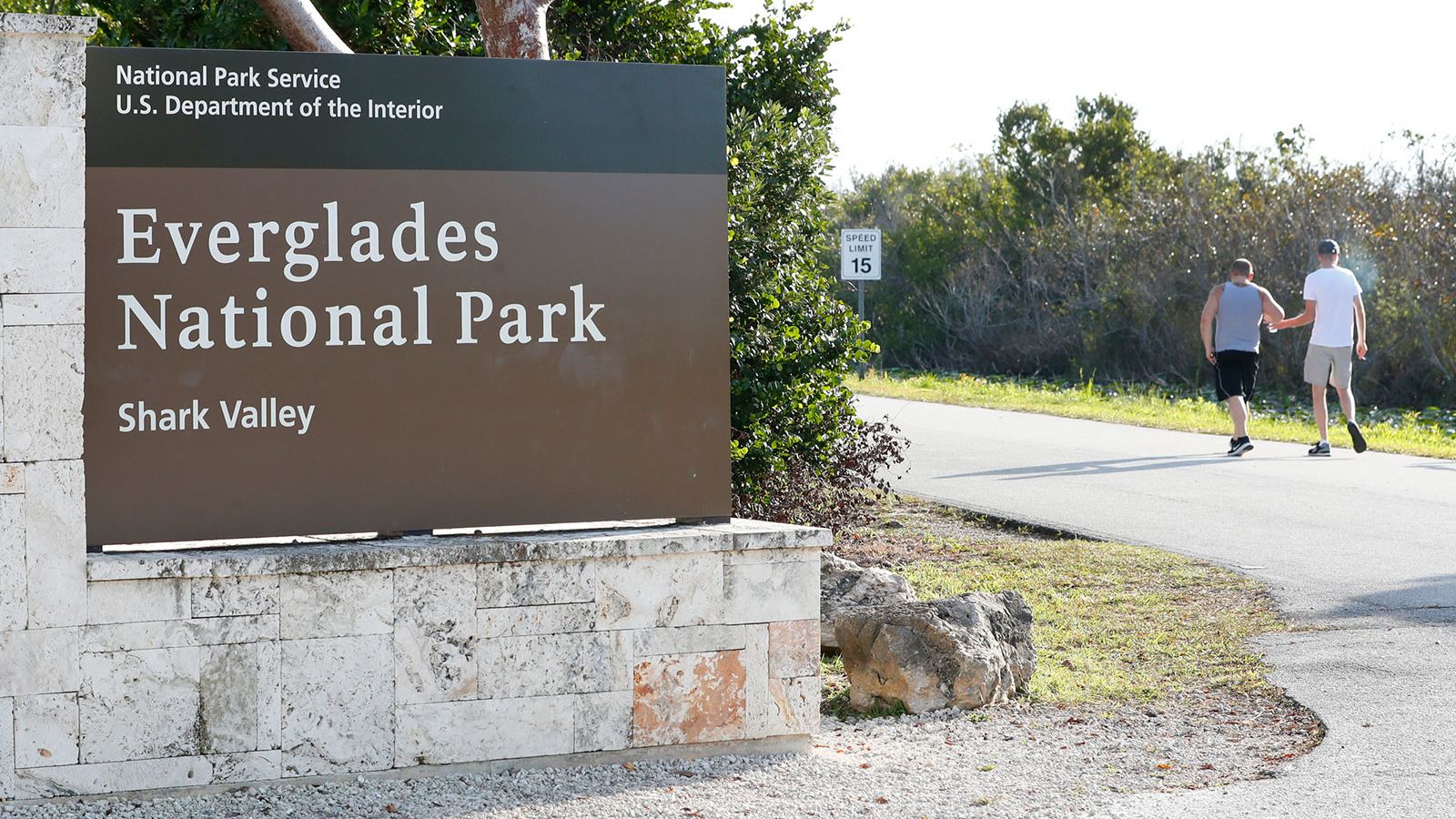 Visitors walk past a sign for Everglades National Park in Florida in this 2019 file photo.