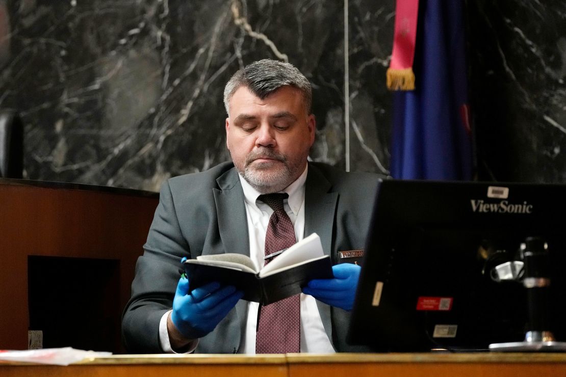 Oakland County Sheriff’s Office Det. Lt. Timothy Willis holds up Ethan Crumbley's journal during the trial of James Crumbley on Tuesday, March 12.