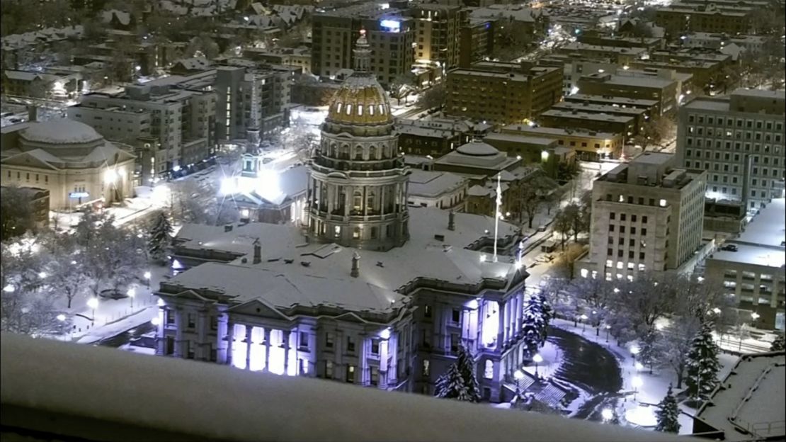 The Colorado State Capitol is covered in snow early Thursday, March 14, 2024 in Denver.