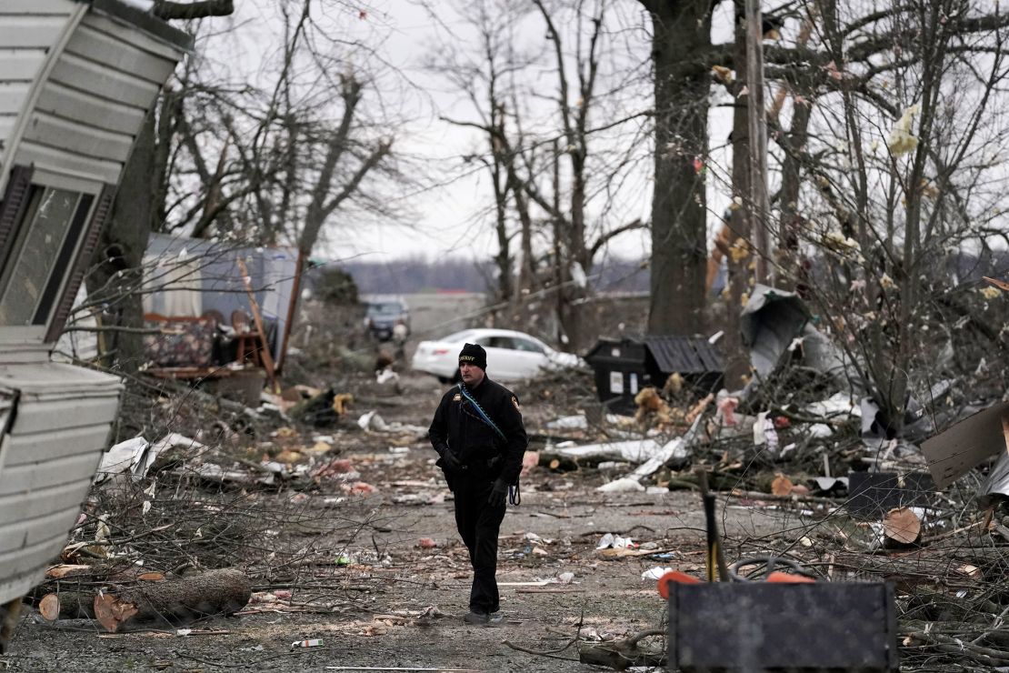 A Logan County sheriff walks down a road Friday following Thursday's severe storm, in Lakeview, Ohio.