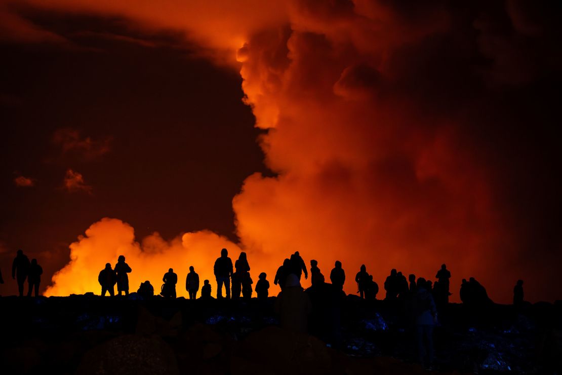Spectators watch plumes of smoke from volcanic activity between Hagafell and Stóra-Skógfell in Iceland on March 16, 2024.
