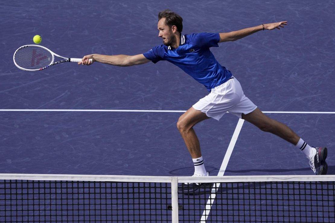 Medvedev reaches for a volley against Alcaraz.
