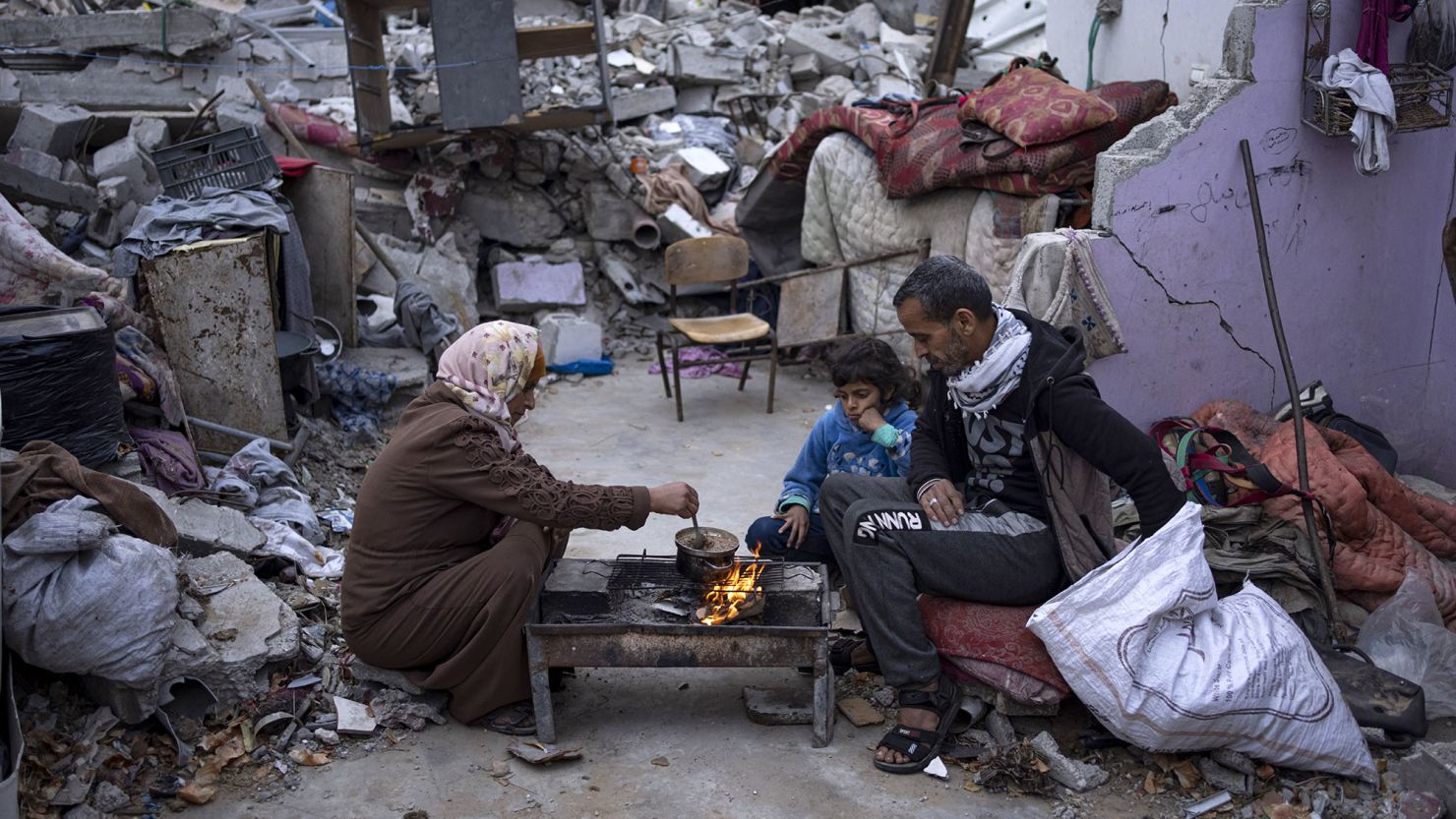 A family break their fast during the Muslim holy month of Ramadan outside their destroyed home in Rafah, Gaza, on March 18.