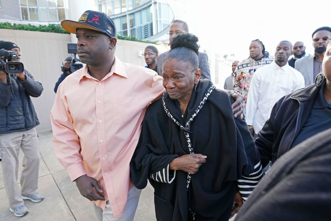 Eddie Terrell Parker, left, escorts Mary Jenkins, mother of Michael Corey Jenkins, into the Thad Cochran United States Courthouse in Jackson, Mississippi, on Tuesday.