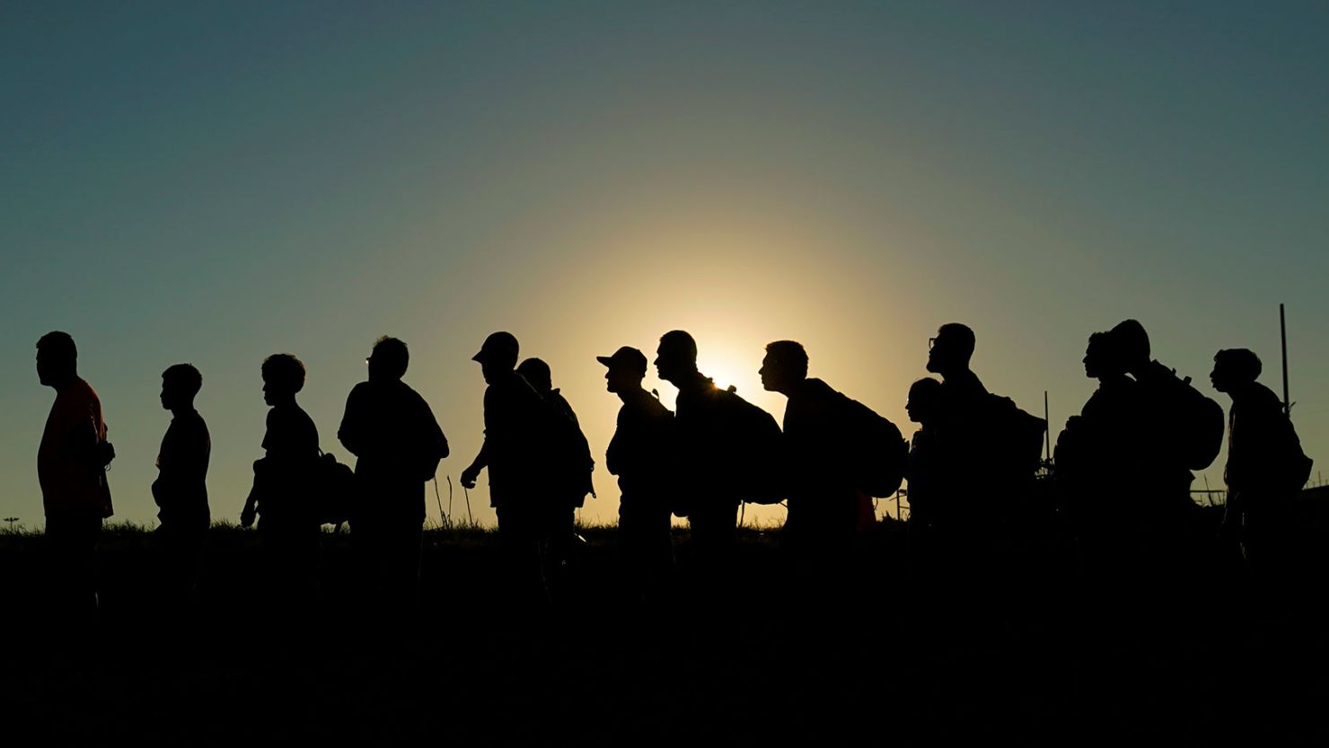 Migrants who crossed the Rio Grande and entered the US from Mexico are lined up for processing in September 2023 in Eagle Pass, Texas.