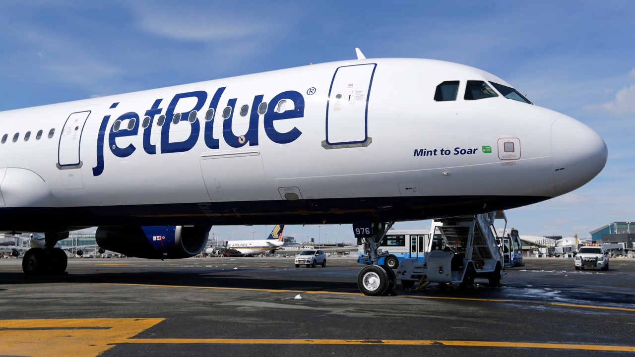 FILE - A JetBlue airplane is seen, March 16, 2017, at John F. Kennedy International Airport in New York. JetBlue Airways will end service at several cities and reduce flying out of Los Angeles in a move to retrench and focus on stronger markets after years of losing money. (AP Photo/Seth Wenig, File)